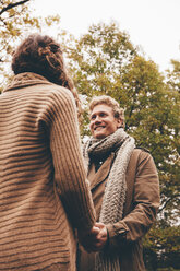 Young couple in love holding hands in an autumnal park - CHAF000219