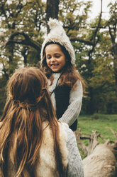 Portrait of little girl looking at her mother in a park - CHAF000239