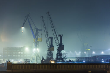 Germany, Hamburg, harbour cranes at Port of Hamburg by night - TAMF000080