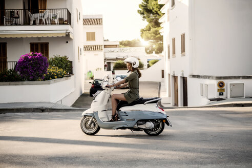 Spain, Majorca, Alcudia, woman on motor scooter - GDF000791