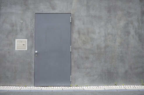 Grey steel door at concrete wall - GUFF000125