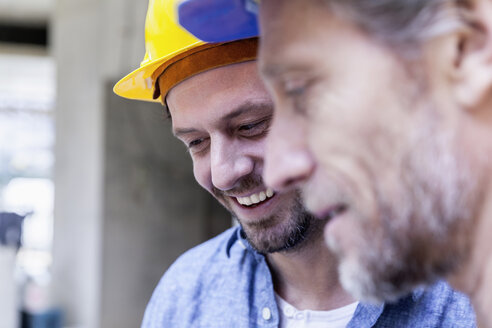 Close-up of two smiling men on construction site - FMKF001688