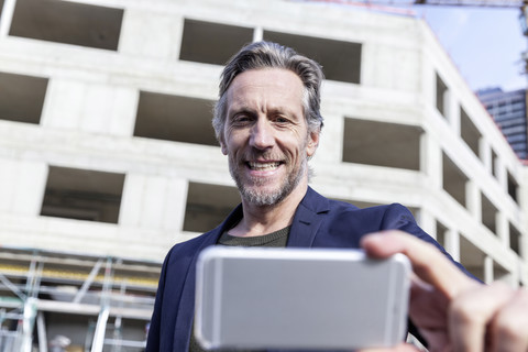 Man taking selfie on construction site stock photo