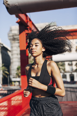 Spain, Barcelona, jogging young woman stock photo