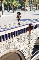 Spain, Barcelona, jogging young woman in the city - EBSF000718