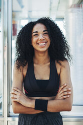 Spain, Barcelona, portrait of smiling young jogger - EBSF000747