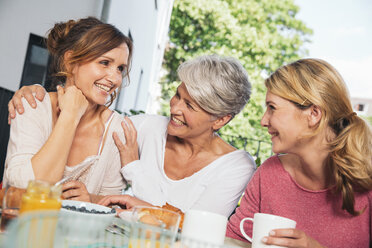 Three women at breakfast table on balcony - MFF001706