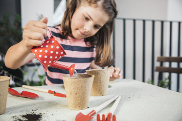 Little girl watering her seeds on balcony - MFF001783