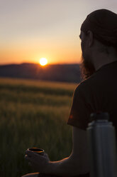 Germany, man waiting for sunrise at country side - MIDF000502