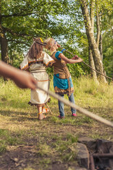 Germany, Saxony, Indians and cowboy party, Girls eating roasted marshmallows - MJF001678