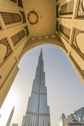 United Arab Emirates, Dubai, The Burj Khalifa framed by a historic arab arch in the evening light - NKF000266