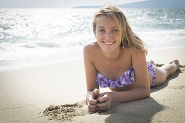 Mexico, Nayarit, teenage girl lying on sandy beach at seafront - ABAF001845