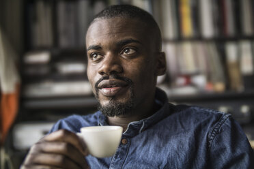 Portrait of young man with cup of coffee - RIBF000124