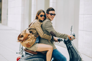 Young couple on motor scooter - CHAF000454