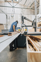 Carpenter working with saw in workshop - JUBF000028