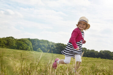 Little girl running on a meadow - STKF001322