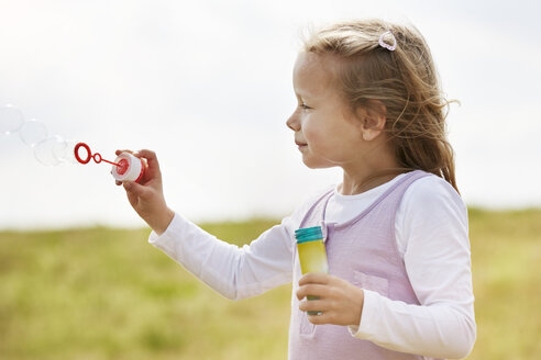 Little children girl blowing soap bubbles - STKF001331
