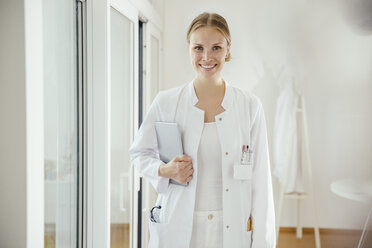 Portrait of smiling female doctor with digital tablet - MFF001829