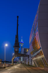 Germany, Duesseldorf, Media Harbour, Harbour crane and Rhine tower, blue hour - FRF000276