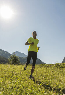 Österreich, Tirol, Tannheimer Tal, junger Mann joggt in alpiner Landschaft - UUF004979