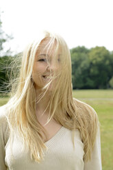 Portrait of smiling blond woman with blowing hair - BFRF001352