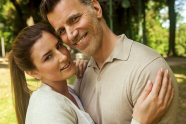 Happy couple embracing in park - CHAF000759