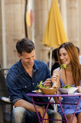 Happy couple meeting in sidewalk restaurant - CHAF000774