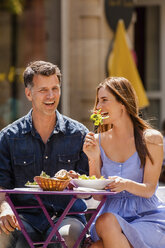 Happy couple meeting in sidewalk restaurant - CHAF000775