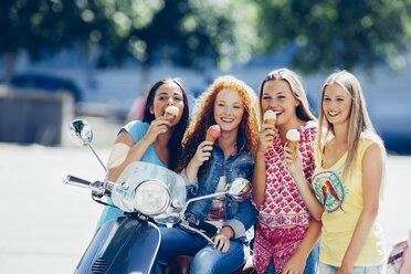 Group picture of four friends with motor scooter and ice cream cones - CHAF000800