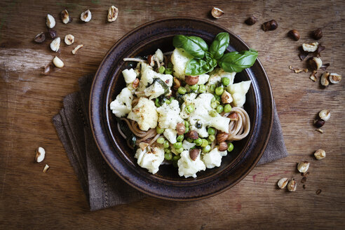 Dish of whole grain spelt spaghetti with roasted cauliflowers, hazelnuts, peas and basil - EVGF002097