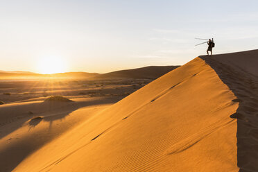 Namibia, Namib Desert, Namib Naukluft National Park, photographer standing on dersert dune - FOF008174