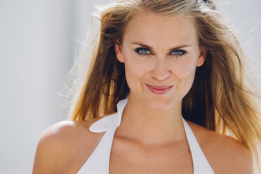 Portrait of smiling blond woman wearing bikini top - CHAF000627