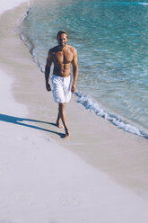 Spain, Majorca, man walking on the beach - CHAF000663