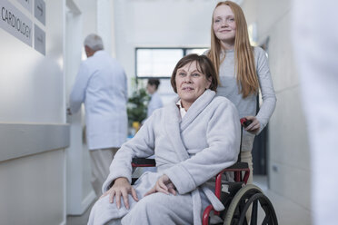 Patient in wheelchair and granddaughter in hospital corridor - ZEF006813