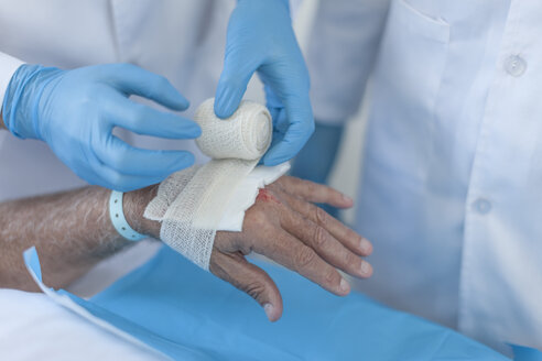 Nurse dressing a wound on patients hand - ZEF006556