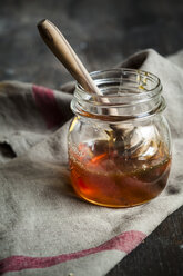 Honey in glass with wooden honey spoon - SBDF002185