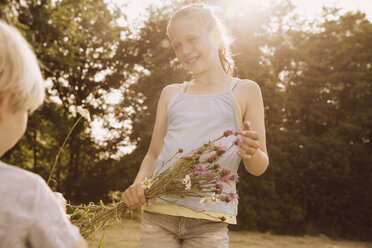 Girl and boy with bunch of thistles and meadow flowers - MFF001914