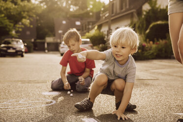 Children using sidewalk chalk in their neighborhood - MFF001947