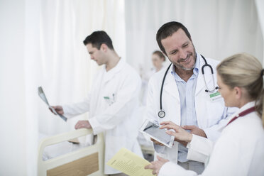 Doctors with digital tablet in a hospital room - ZEF006240