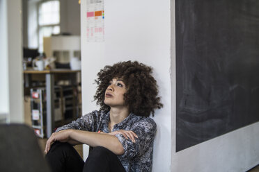 Young woman in office thinking - FKF001215