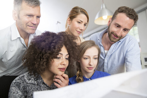 Colleagues in office looking at plan - FKF001262