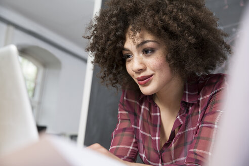 Young woman in office using laptop - FKF001297