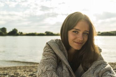 Portrait of smiling young woman by the riverside - UUF004989