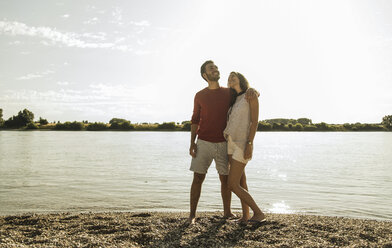 Young couple walking by the riverside - UUF005018