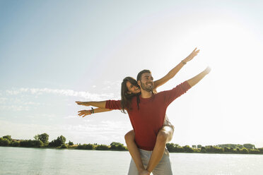 Carefree young couple by the river - UUF005042