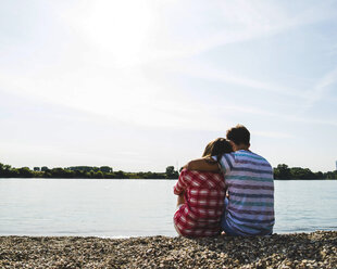 Young couple sitting by the riverside - UUF005030