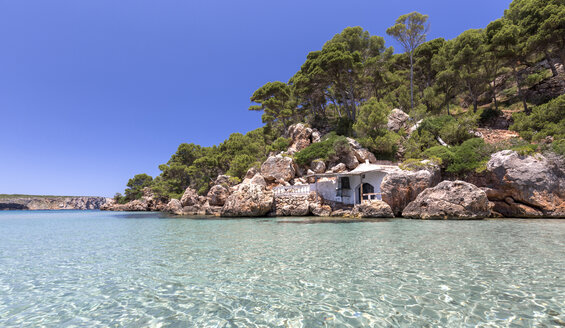 Spain, Balearic Islands, Menorca, abandoned house on the rocks in La Vall beach - MGOF000338