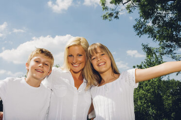 Portrait of happy mother with her children in nature - CHAF000902