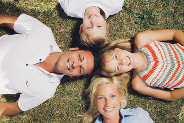 Happy family lying on a meadow - CHAF000926