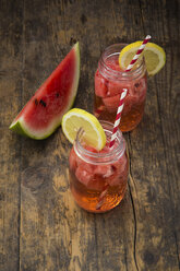 Glasses of homemade watermelon lemonade on wood - LVF003733